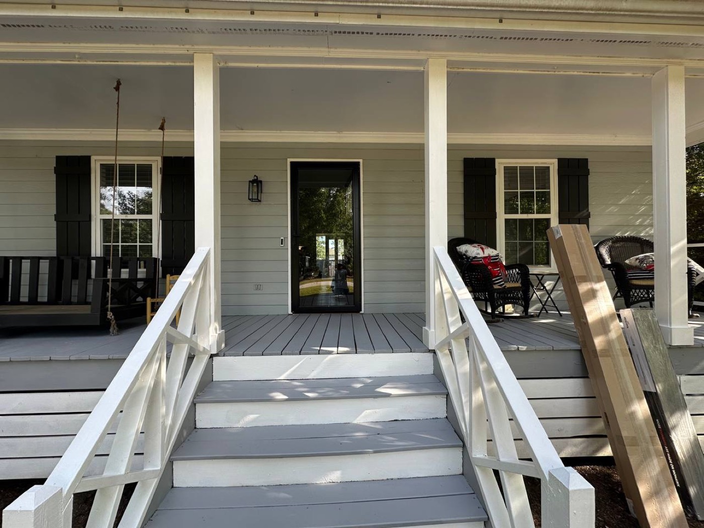 Front porch with freshly painted railings, steps and floor